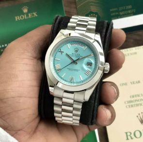 Elevate your style with this original Swiss-made Rolex Day date watch for men. Featuring a stainless steel body, silver bezel ring, and sky blue dial.